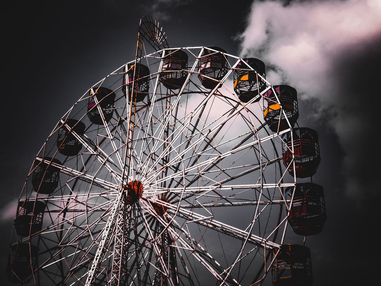 a ferris wheel with a cloudy sky